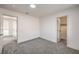 Bright bedroom with neutral carpet, fresh white paint, and two doorways at 2107 Fountain Springs Dr, Henderson, NV 89074