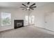 Bright, carpeted bedroom with a modern ceiling fan, fireplace, and access to a bathroom at 2107 Fountain Springs Dr, Henderson, NV 89074
