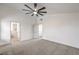Large carpeted bedroom with access to a bathroom and closet, modern ceiling fan at 2107 Fountain Springs Dr, Henderson, NV 89074