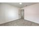Bright bedroom featuring neutral carpet and base trim with open door to hallway at 2107 Fountain Springs Dr, Henderson, NV 89074