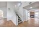 Bright entryway features modern staircase, wood flooring, and seamless access to the living area at 2107 Fountain Springs Dr, Henderson, NV 89074