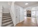 Home entryway with carpeted stairs leading upstairs and view of the living room with fireplace at 2107 Fountain Springs Dr, Henderson, NV 89074