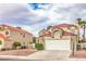 Charming two-story home with tile roof, two-car garage, and mature landscaping at 2107 Fountain Springs Dr, Henderson, NV 89074
