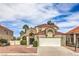 Charming two-story home with a tile roof, blue front door, and a well-manicured landscape at 2107 Fountain Springs Dr, Henderson, NV 89074