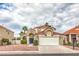 Two-story home with a red tile roof, well-manicured landscaping, and a two-car garage at 2107 Fountain Springs Dr, Henderson, NV 89074
