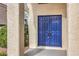 Inviting home entrance featuring a bold blue double door with textured stucco columns at 2107 Fountain Springs Dr, Henderson, NV 89074
