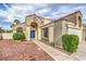 Inviting two-story home with a tile roof, landscaped front yard, and a charming blue front door at 2107 Fountain Springs Dr, Henderson, NV 89074