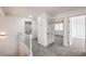 Upstairs hallway with neutral carpet and access to multiple bedrooms and bathrooms at 2107 Fountain Springs Dr, Henderson, NV 89074