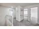 Upstairs hallway with multiple doors, neutral carpet, and modern lighting at 2107 Fountain Springs Dr, Henderson, NV 89074