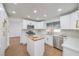 Bright kitchen features stainless steel appliances, white cabinets, quartz counters, and a butcher block island at 2107 Fountain Springs Dr, Henderson, NV 89074