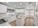 Bright kitchen features quartz countertops, white cabinetry, island, and stainless steel appliances at 2107 Fountain Springs Dr, Henderson, NV 89074