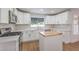 Modern kitchen with white cabinets, stainless steel appliances, and an island with butcher block at 2107 Fountain Springs Dr, Henderson, NV 89074