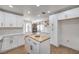 Spacious kitchen with stainless appliances, white cabinetry, a butcher block island, and open access to the living room at 2107 Fountain Springs Dr, Henderson, NV 89074