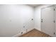 A clean laundry room with modern flooring, white walls, and a white door at 2107 Fountain Springs Dr, Henderson, NV 89074