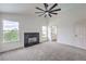 Large living room with ceiling fan, modern fireplace, and abundant natural light at 2107 Fountain Springs Dr, Henderson, NV 89074