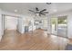 Spacious living room with a bar, ceiling fan, hardwood floors, and sliding glass doors at 2107 Fountain Springs Dr, Henderson, NV 89074
