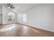 Bright living room with vaulted ceilings, a ceiling fan, and wood-look floors at 2107 Fountain Springs Dr, Henderson, NV 89074