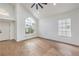 Bright living room with vaulted ceilings, a ceiling fan, and wood-look floors at 2107 Fountain Springs Dr, Henderson, NV 89074