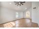 Bright living room with high ceilings, a ceiling fan and multiple windows at 2107 Fountain Springs Dr, Henderson, NV 89074