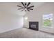 Light-filled living room with a modern ceiling fan and sleek black fireplace at 2107 Fountain Springs Dr, Henderson, NV 89074