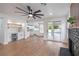 Spacious living room featuring a fireplace, ceiling fan, and seamless access to the kitchen and outdoor pool area at 2107 Fountain Springs Dr, Henderson, NV 89074