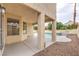 Covered outdoor patio with view of the backyard pool and rock landscaping at 2107 Fountain Springs Dr, Henderson, NV 89074