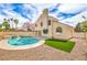Backyard pool features a spa and rock landscaping complemented by a stucco house, perfect for outdoor relaxation at 2107 Fountain Springs Dr, Henderson, NV 89074