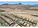 A neighborhood with uniform houses under a clear sky with mountain views near a highway and commercial buildings at 2276 Sky Island Dr, Henderson, NV 89002