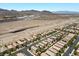 A neighborhood with similar houses is visible under a clear sky, a highway, and commercial buildings at 2276 Sky Island Dr, Henderson, NV 89002