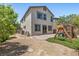 A backyard with a play structure, brick patio, and landscaping for outdoor entertainment at 2276 Sky Island Dr, Henderson, NV 89002