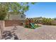 Enjoy this backyard featuring a brick patio, play structure, and well-kept landscaping at 2276 Sky Island Dr, Henderson, NV 89002