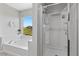 Bright bathroom featuring a soaking tub and separate glass-enclosed shower at 2276 Sky Island Dr, Henderson, NV 89002