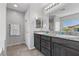 Bathroom features double sinks with granite countertops, bright lighting, and a tile floor at 2276 Sky Island Dr, Henderson, NV 89002