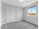 Cozy bedroom featuring neutral walls, carpet, and closet with window view at 2276 Sky Island Dr, Henderson, NV 89002