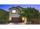 Charming two-story home featuring a brown garage door, stone accents, and manicured landscaping at 2276 Sky Island Dr, Henderson, NV 89002