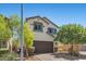 Charming two-story home featuring a brown garage door, stone accents, and manicured landscaping at 2276 Sky Island Dr, Henderson, NV 89002