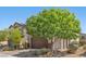 Charming two-story home featuring a brown garage door, stone accents, and manicured landscaping at 2276 Sky Island Dr, Henderson, NV 89002