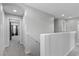 Bright hallway featuring neutral walls and carpeted floors, leading to bedrooms at 2276 Sky Island Dr, Henderson, NV 89002
