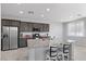 Updated kitchen with granite countertops, stainless steel appliances and an island with seating at 2276 Sky Island Dr, Henderson, NV 89002