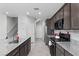 Modern kitchen with stainless appliances, granite counters and a large island with sink at 2276 Sky Island Dr, Henderson, NV 89002