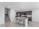 Open kitchen with granite counters, stainless appliances and an island with barstool seating at 2276 Sky Island Dr, Henderson, NV 89002