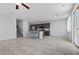 Open-concept living room and kitchen area with natural light and neutral tile flooring at 2276 Sky Island Dr, Henderson, NV 89002