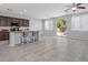 Open living space featuring an island kitchen, tile flooring, and access to the backyard at 2276 Sky Island Dr, Henderson, NV 89002