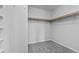 Neat walk-in closet with rods and shelving with neutral walls and carpeted floors at 2276 Sky Island Dr, Henderson, NV 89002