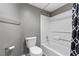 Bathroom featuring a toilet, shower-tub combo with a black and white shower curtain at 231 W Horizon Ridge Pkwy # 1228, Henderson, NV 89012