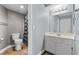 Bathroom featuring a toilet, shower-tub combo, vanity, and framed mirror at 231 W Horizon Ridge Pkwy # 1228, Henderson, NV 89012