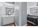 Bright bathroom with a white vanity, a large mirror, and a toilet with shower at 231 W Horizon Ridge Pkwy # 1228, Henderson, NV 89012