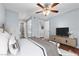 Light-filled bedroom with ensuite bathroom access, wood floors, and a modern ceiling fan at 231 W Horizon Ridge Pkwy # 1228, Henderson, NV 89012