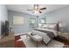 Cozy bedroom featuring a ceiling fan, natural light from two windows, and neutral decor at 231 W Horizon Ridge Pkwy # 1228, Henderson, NV 89012