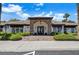 Clubhouse exterior with stone accents, accessible entrance, and manicured landscaping at 231 W Horizon Ridge Pkwy # 1228, Henderson, NV 89012